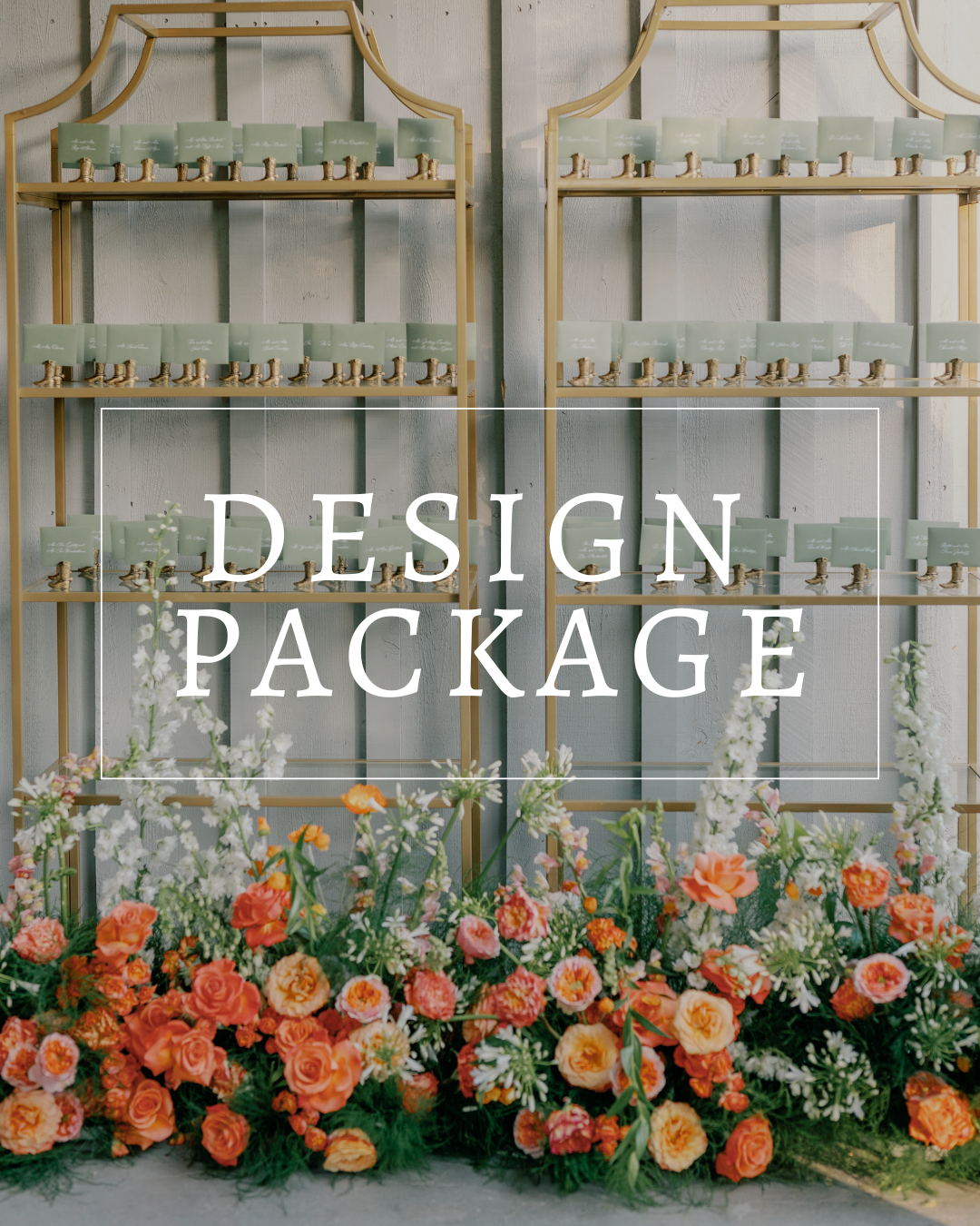 Two tall, gold-framed shelves displaying place cards above a lush arrangement of orange and white flowers.