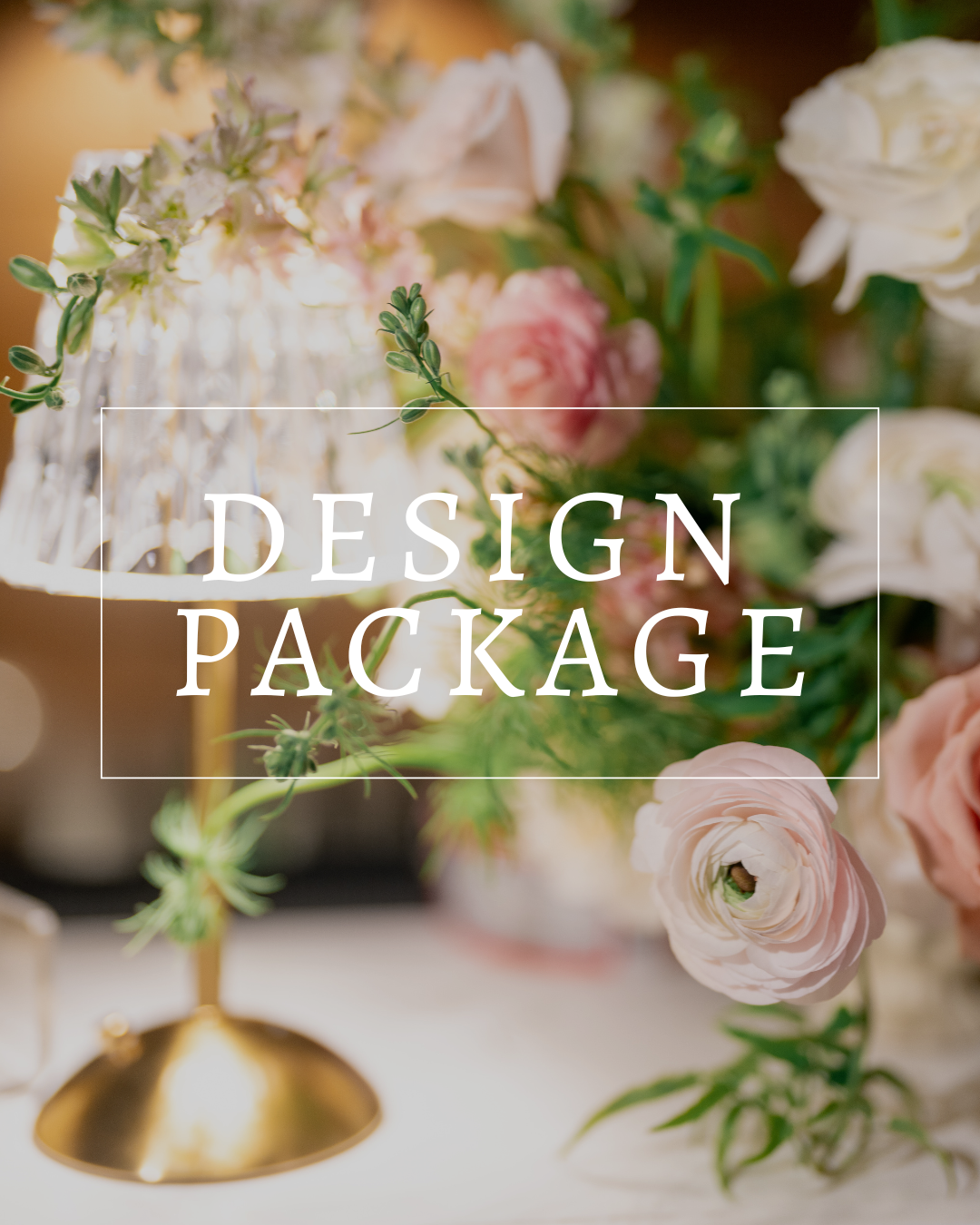 A golden pedestal holds a delicate floral arrangement in soft pinks and whites, with