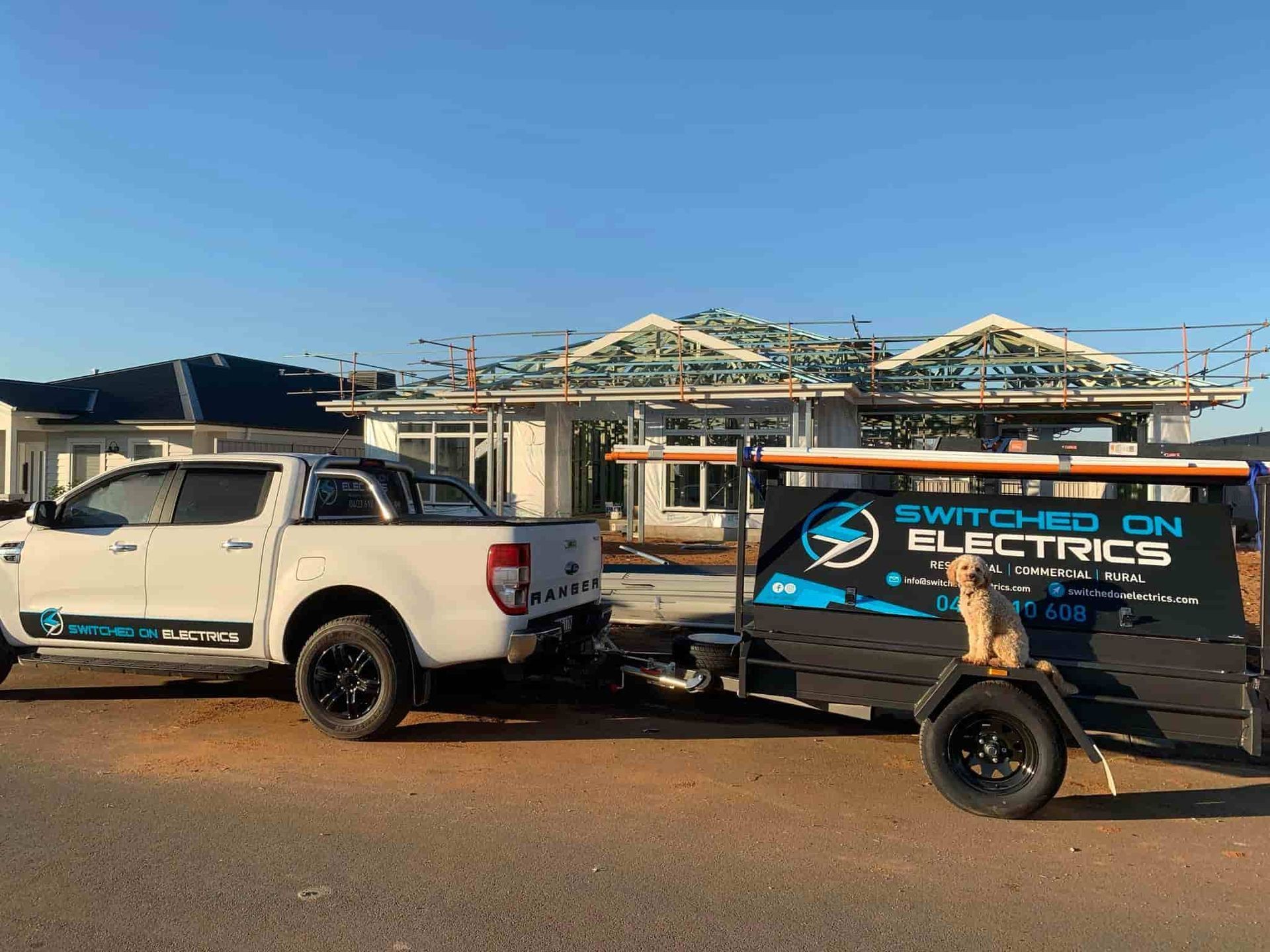 White Pickup Truck With Trailer Parked at a Construction Site — Switched On Electrics in Wagga Wagga, NSW
