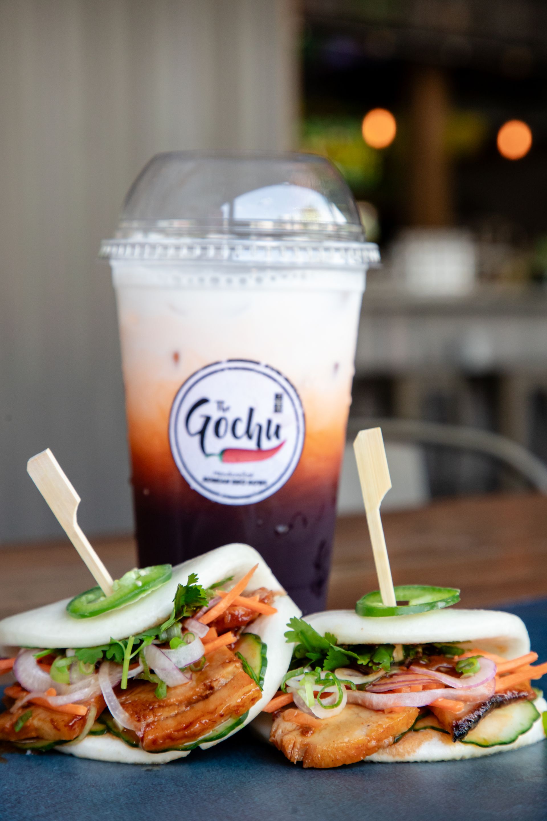 A couple of sandwiches and a drink on a table.