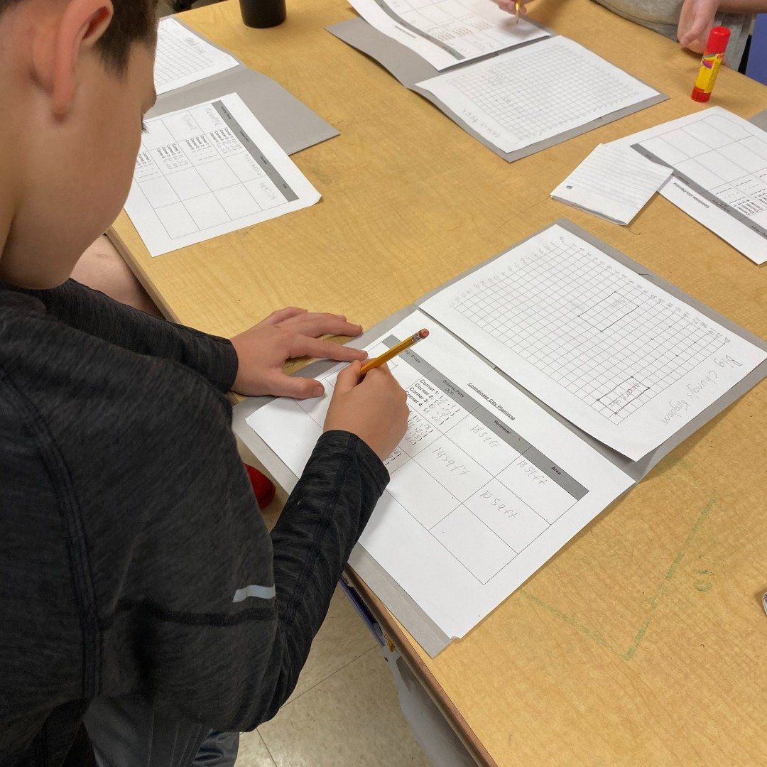 A boy is writing on a piece of paper that says review
