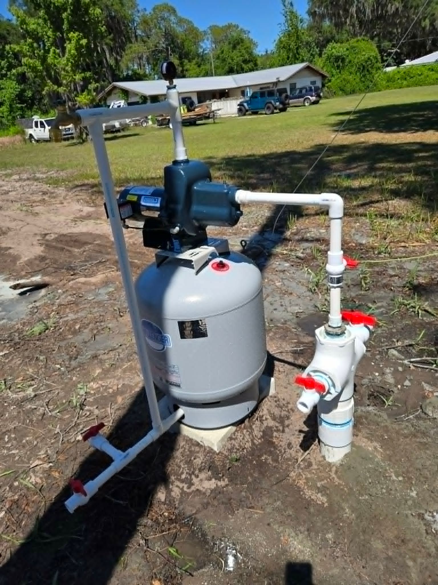 Blue STA-RITE water pump with pressure gauge and electrical components.