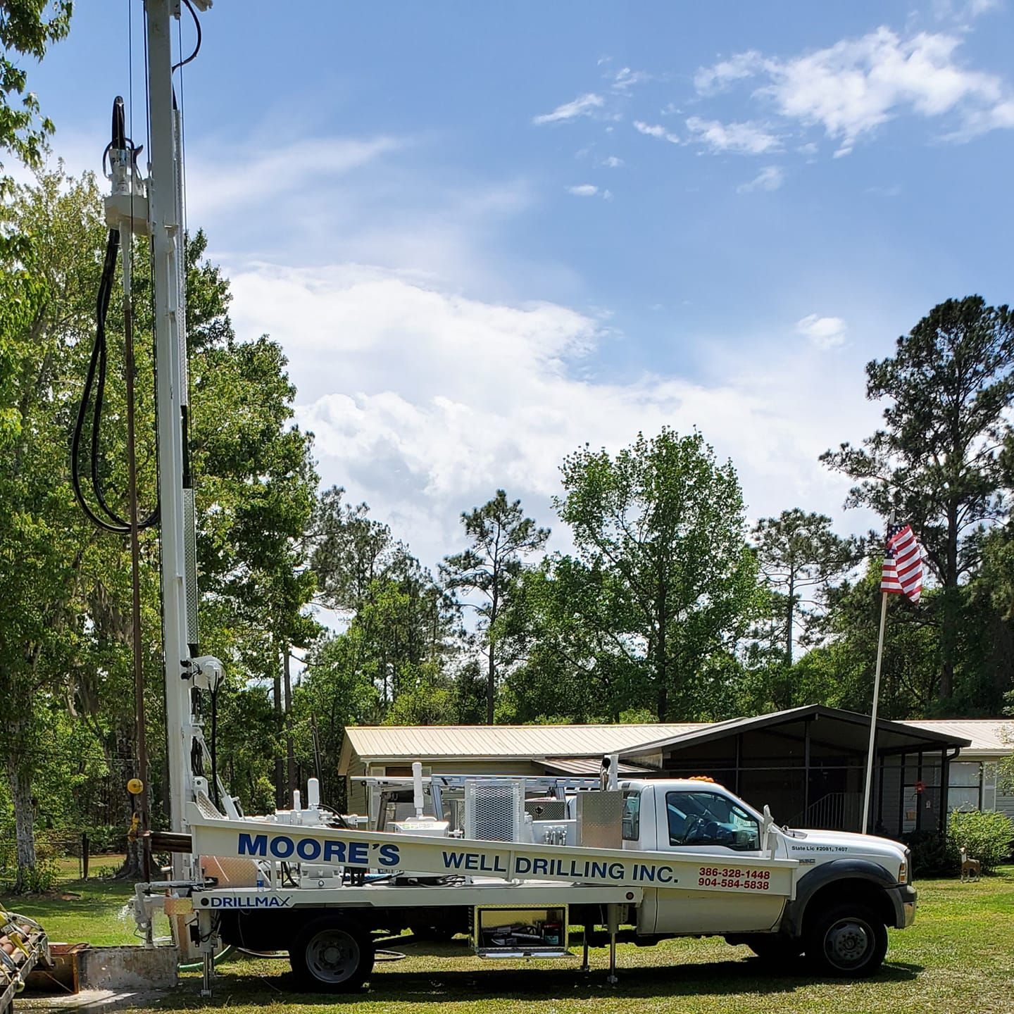 White Water Pump — Palatka, Fl — Moore’s Well Drilling White well drilling truck parked in a wooded area, drilling rig extended.