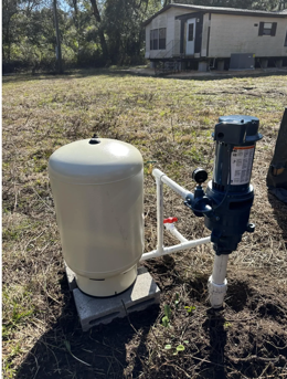 Above-ground well pump and pressure tank installed outside a rural home in Palatka, FL. Above-ground well pump and pressure tank installed outside a rural home in Palatka, FL.