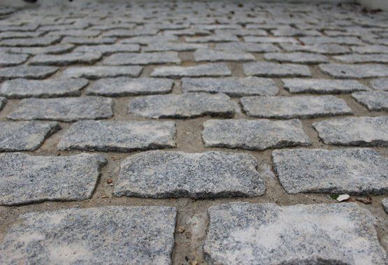 Close-up of grey granite setts laid with wide joints