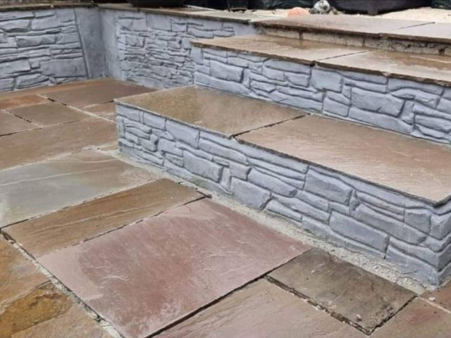 Indian stone patio and steps with grey stone-effect walling