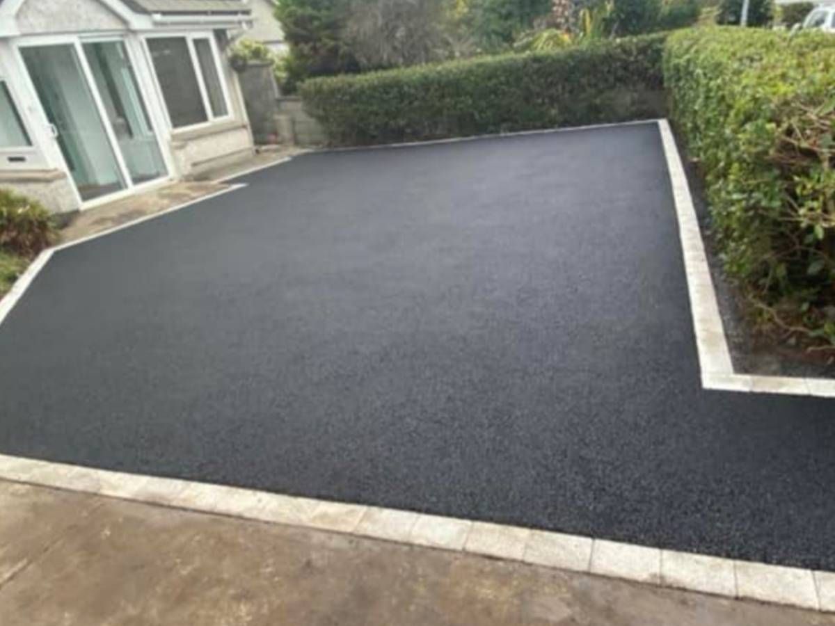 Driveways Sheffield black tarmac driveway with light grey block paving edging