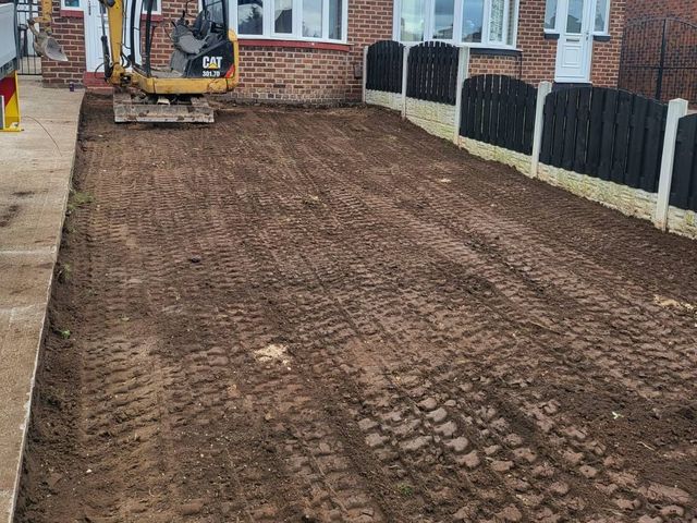 Mini digger and dug-out ground ready for a new concrete driveway in Sheffield