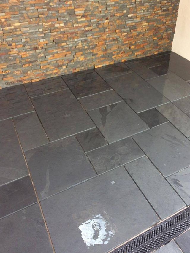 Dark slate patio in a small back garden in Sheffield