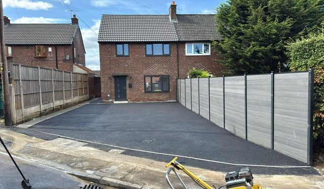 Light grey composite fencing installed alongside a new tarmac driveway in Sheffield