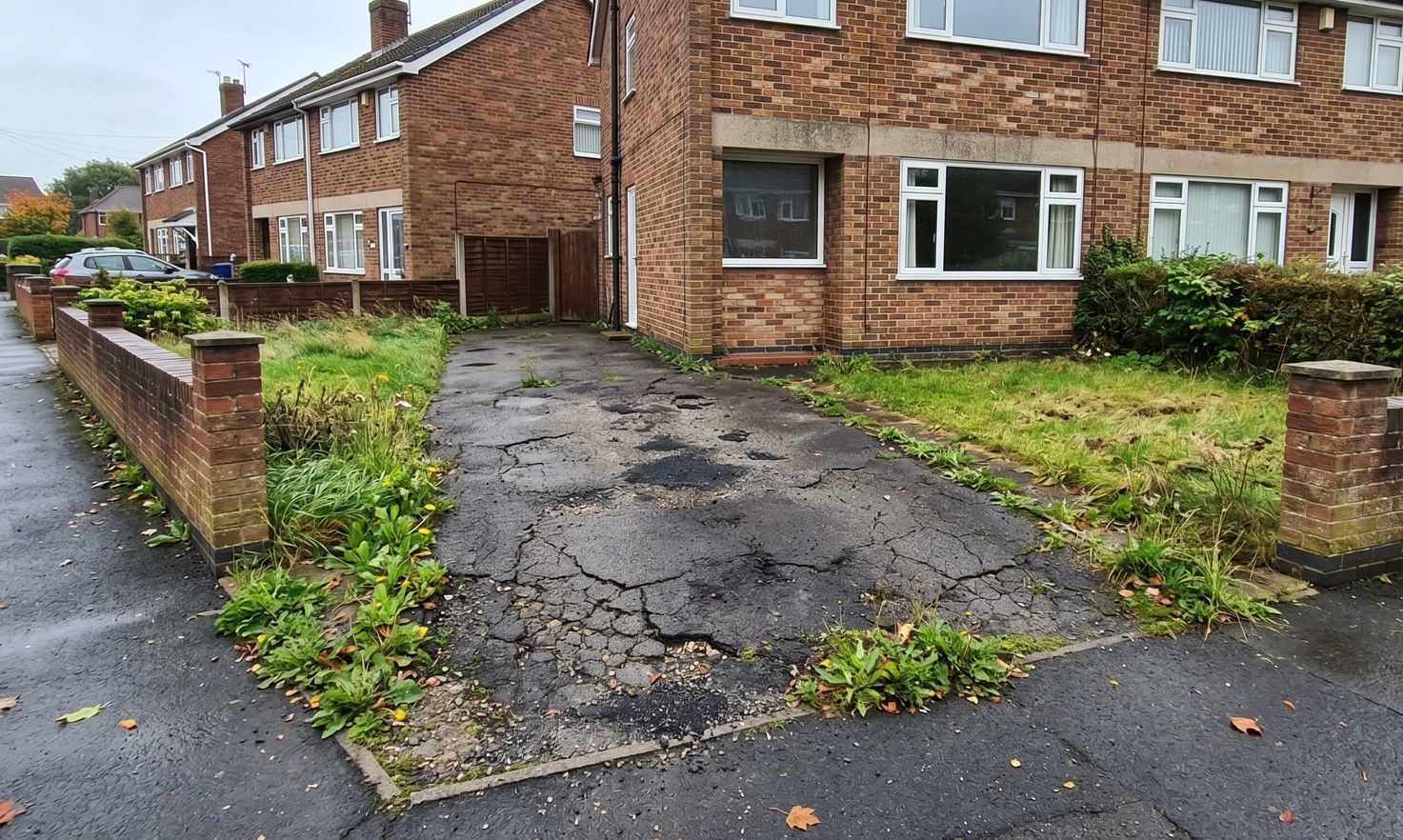 Old deteriorated tarmac driveway before replacement in Killamarsh Derbyshire