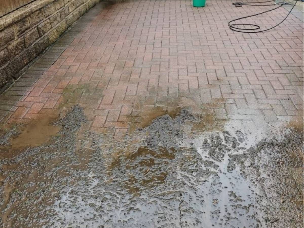 partway through cleaning a block paving driveway