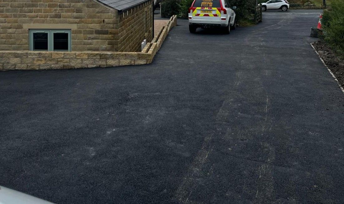 Driveways Sheffield large black tarmac driveway with parking spaces