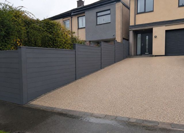 Grey composite fencing beside a new resin bound driveway in Sheffield