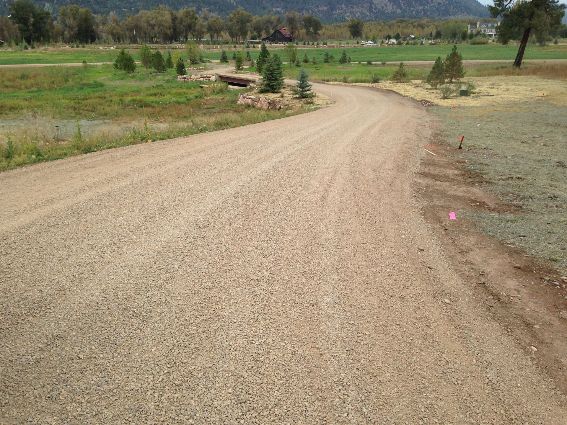 A dirt road with trees on the side of it