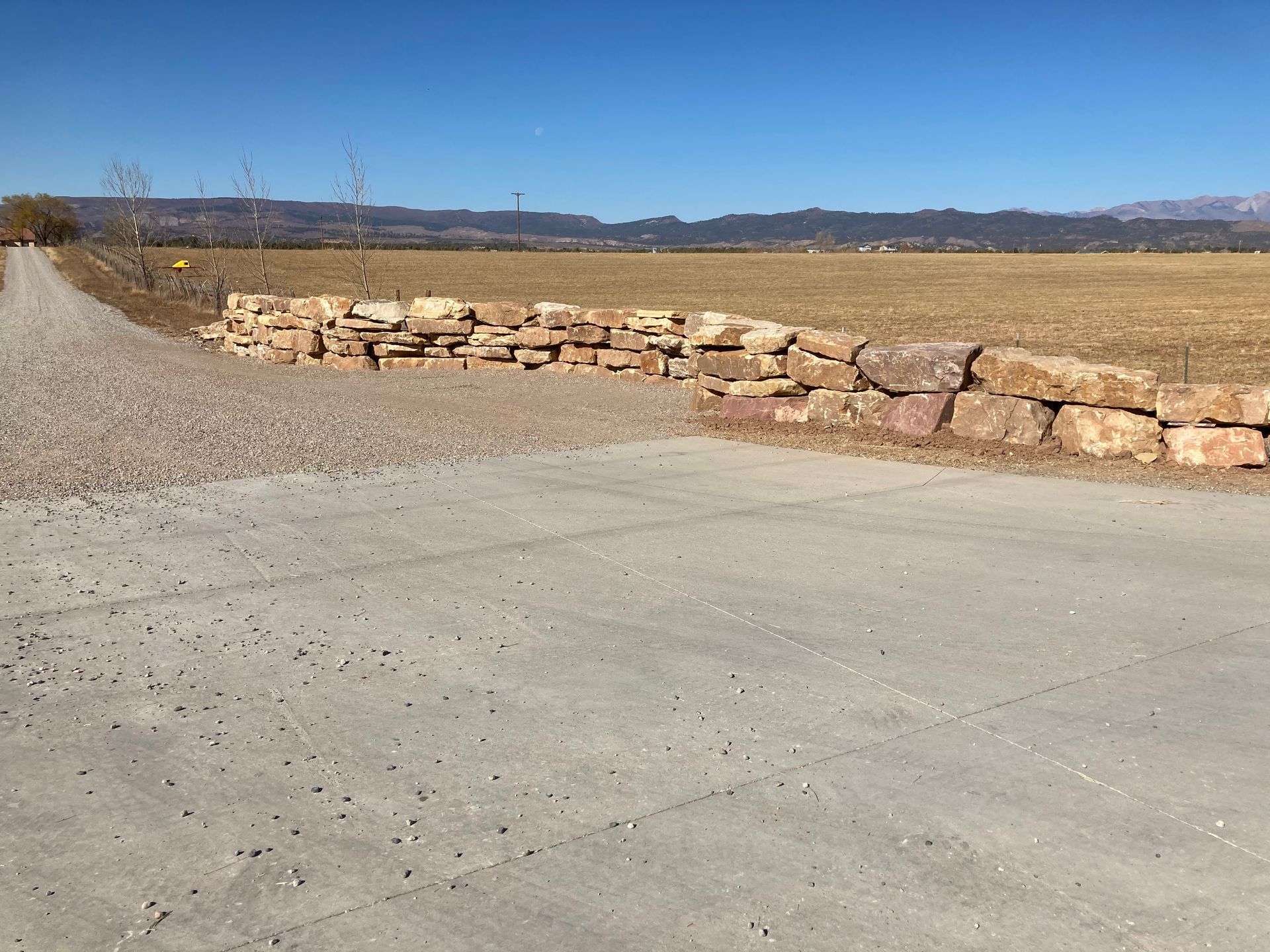 Sunnyside Gravel and Excavation, contractors in Durango CO La Plata county gravel road with a stone wall 