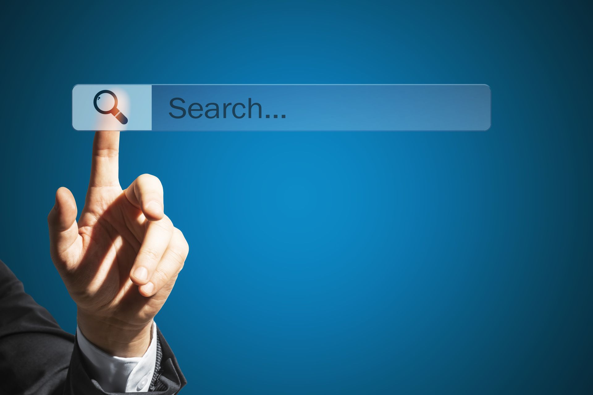 Hand pressing search bar with magnifying glass icon on blue background