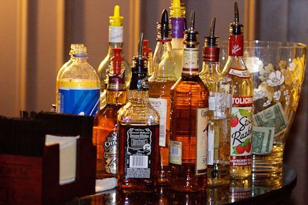 A Man Is Serving a Woman a Drink at A Bar - Lee’s Summit, MO - Top Shelf Bartending Services, LLC