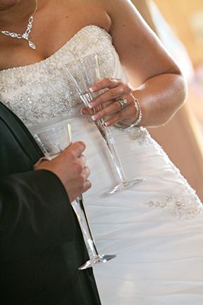A Bride and Groom Are Holding Champagne Glasses in Their Hands - Lee’s Summit, MO - Top Shelf Bartending Services, LLC