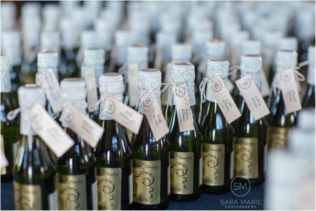 A Bunch of Bottles of Wine with Tags on Them Are Lined up On a Table - Lee’s Summit, MO - Top Shelf Bartending Services, LLC