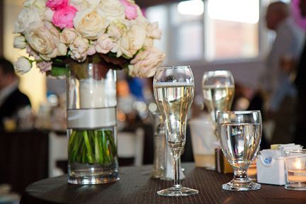 A Vase of Flowers and Champagne Glasses on A Table - Lee’s Summit, MO - Top Shelf Bartending Services, LLC