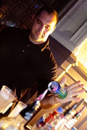 A Man Is Pouring a Drink from A Can Into a Glass - Lee’s Summit, MO - Top Shelf Bartending Services, LLC