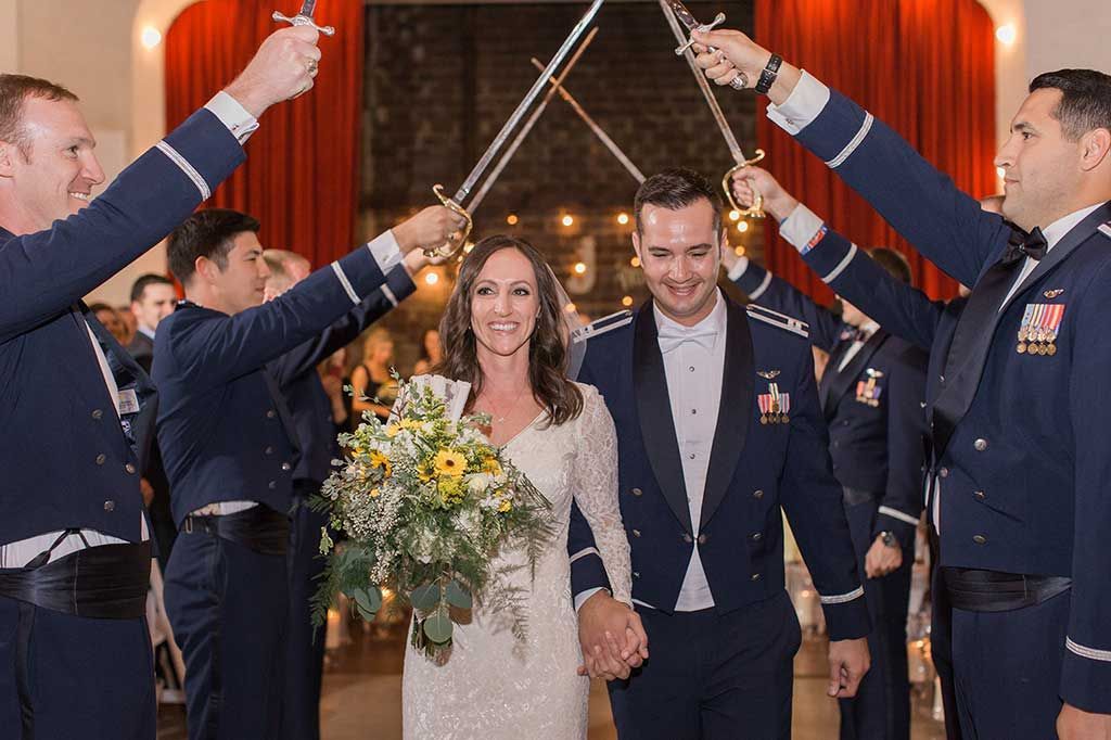 A Bride and Groom Are Walking Down the Aisle with Swords in The Air - Lee’s Summit, MO - Top Shelf Bartending Services, LLC