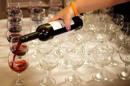 A Person Is Pouring Wine Into Wine Glasses on A Table - Lee’s Summit, MO - Top Shelf Bartending Services, LLC