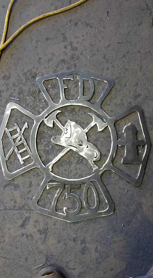 Close-up of a weathered metal emblem with “FMC” and “1500” on a gray surface.