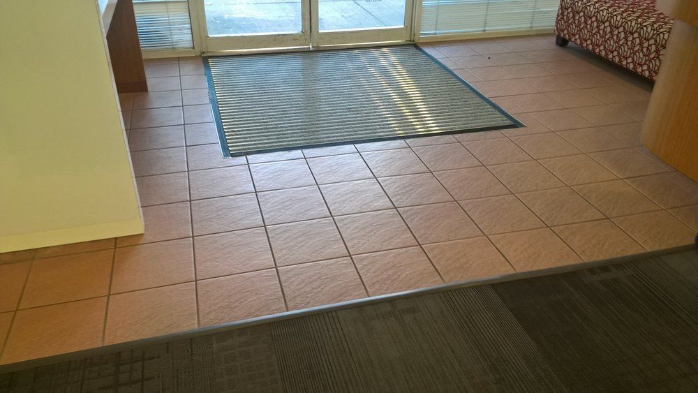 There is a rug on the floor in the middle of the room.