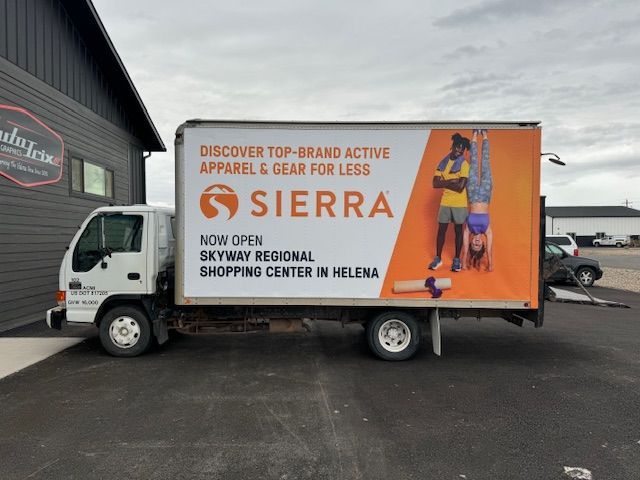 White truck with Sierra advertisement: active apparel and gear, Skyway Regional Shopping Center in Helena.
