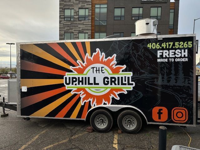 The Uphill Grill food truck with orange and black sunburst design, phone number, and social media icons.