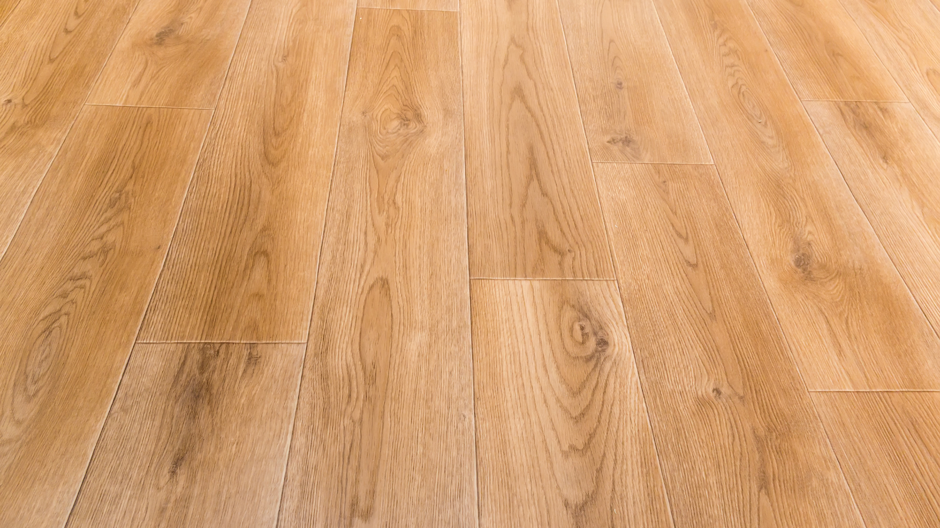Wooden floorboards, light brown, in perspective.