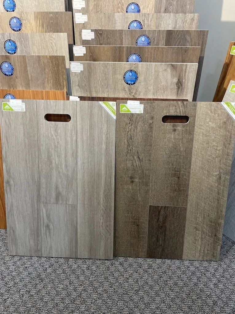 Floor samples in shades of gray, brown, and tan arranged in a display.