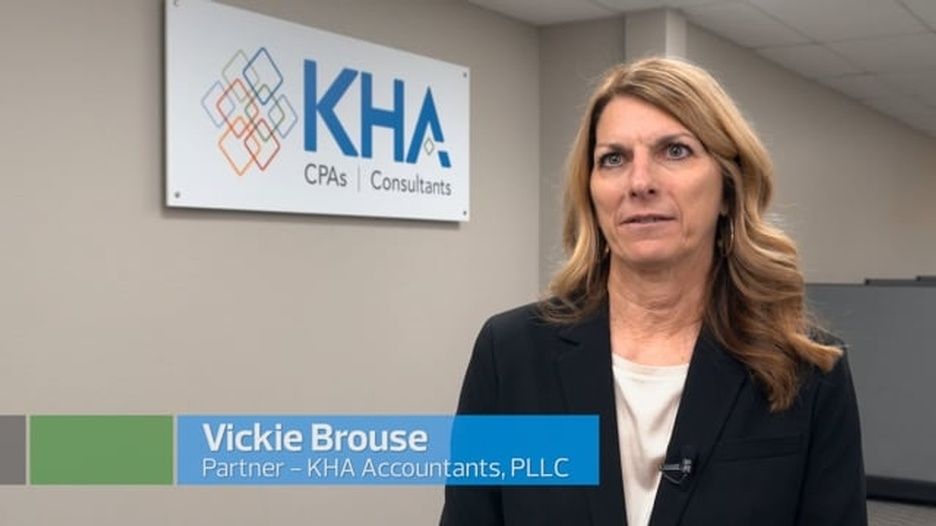 A woman is standing in front of a kha sign