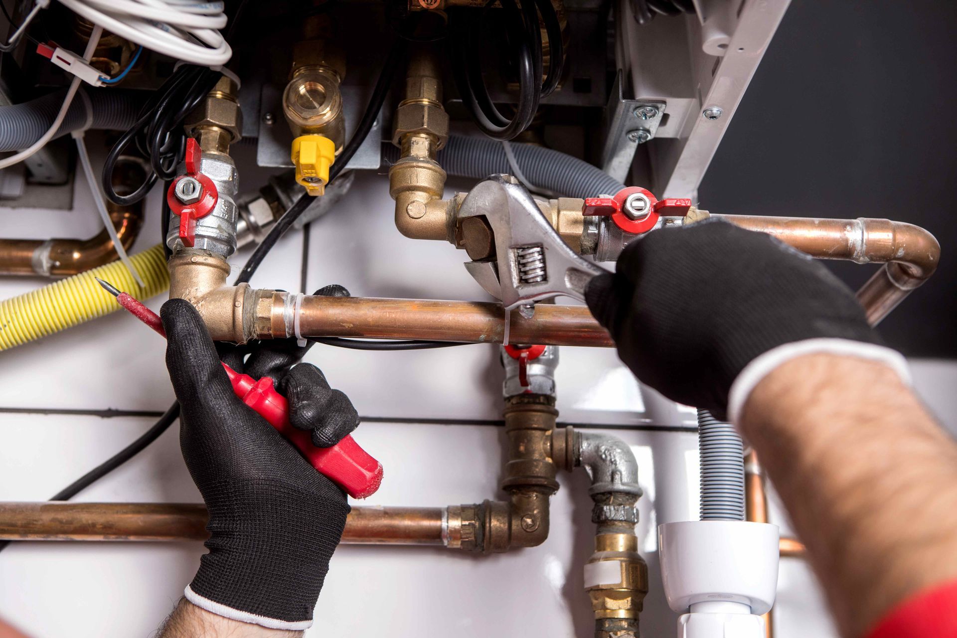 Plumber repairing copper pipe connections.