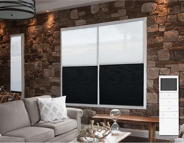Living room with stone wall, sofa, window with black and white blinds, and a white control panel.