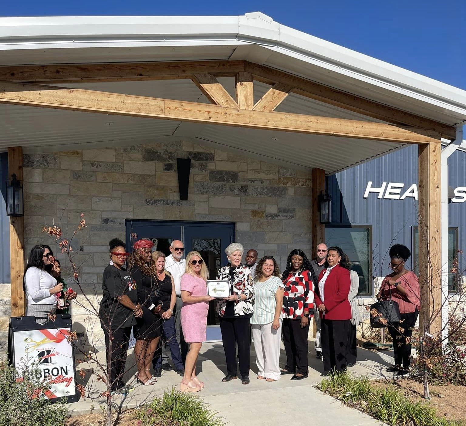 A group of people are standing in front of a building.