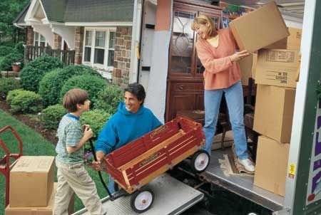 A family is loading boxes into a moving truck.