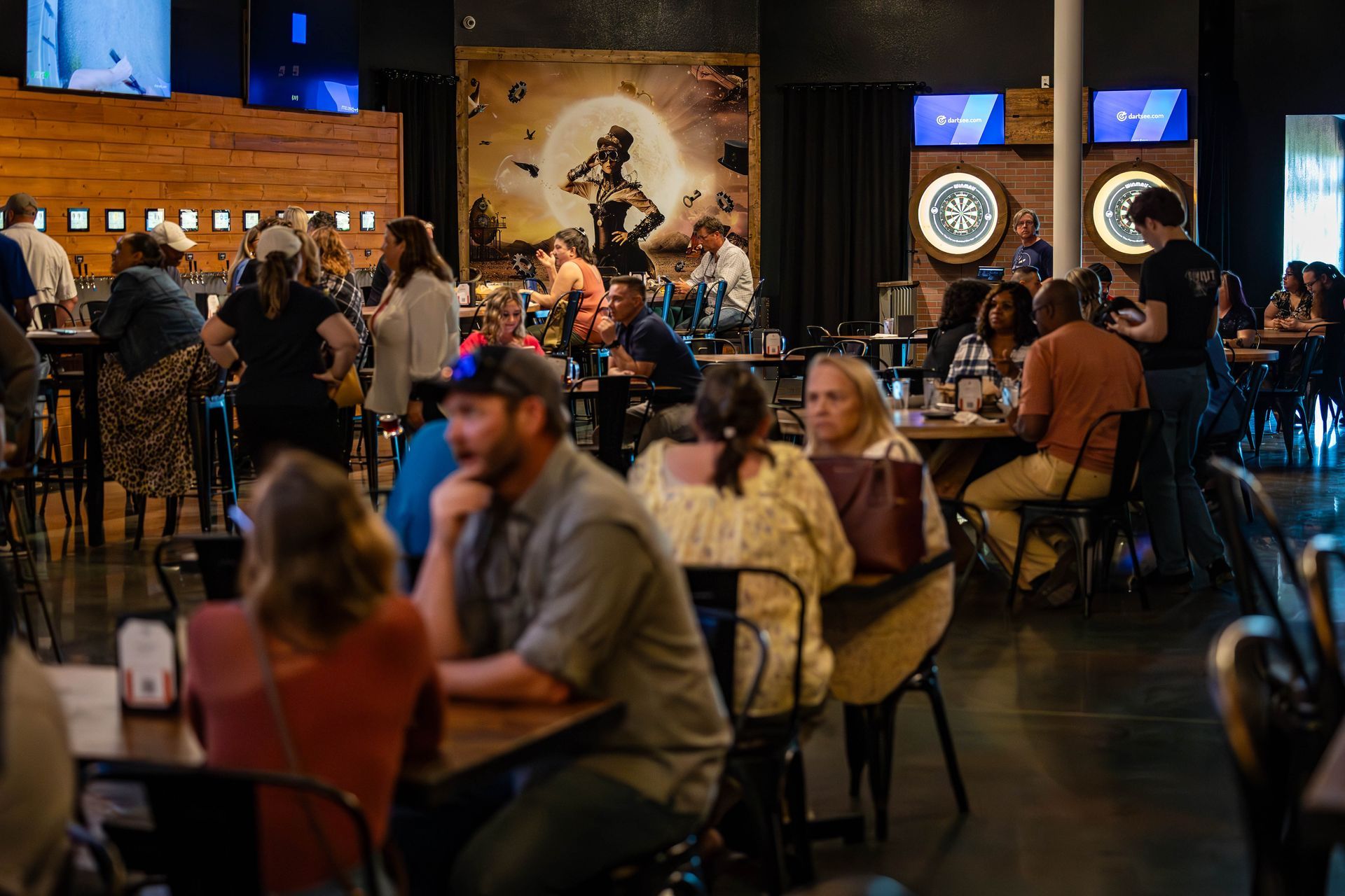 A group of people are sitting at tables in a restaurant.