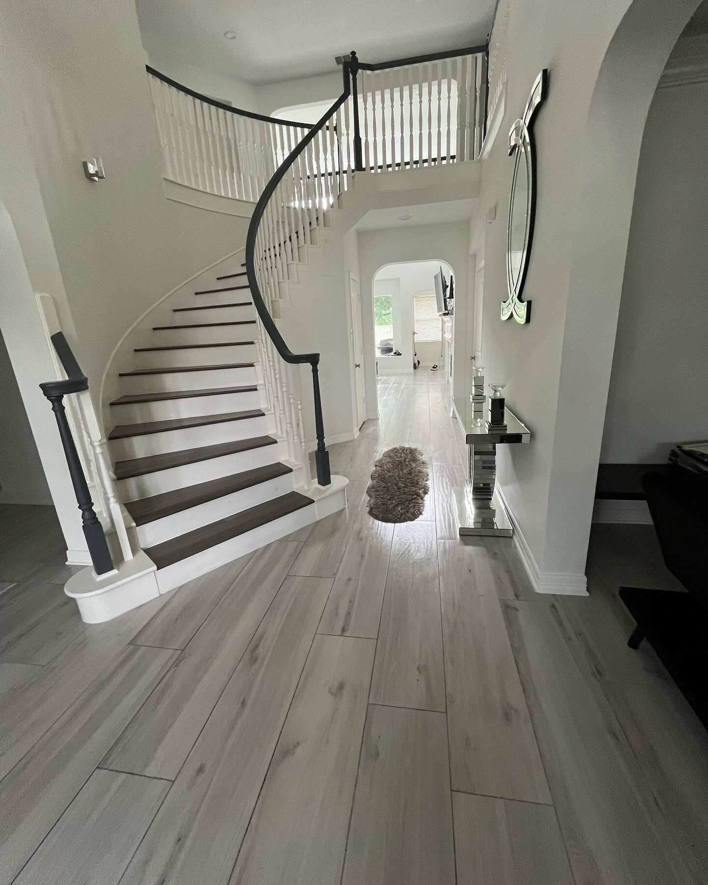 There is a spiral staircase in the middle of the hallway.