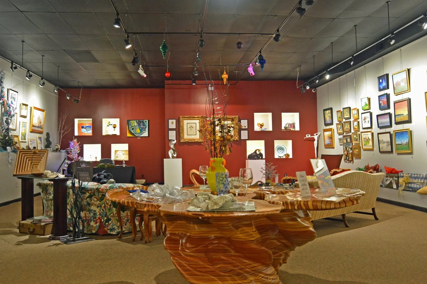 A room with a table and paintings on the wall