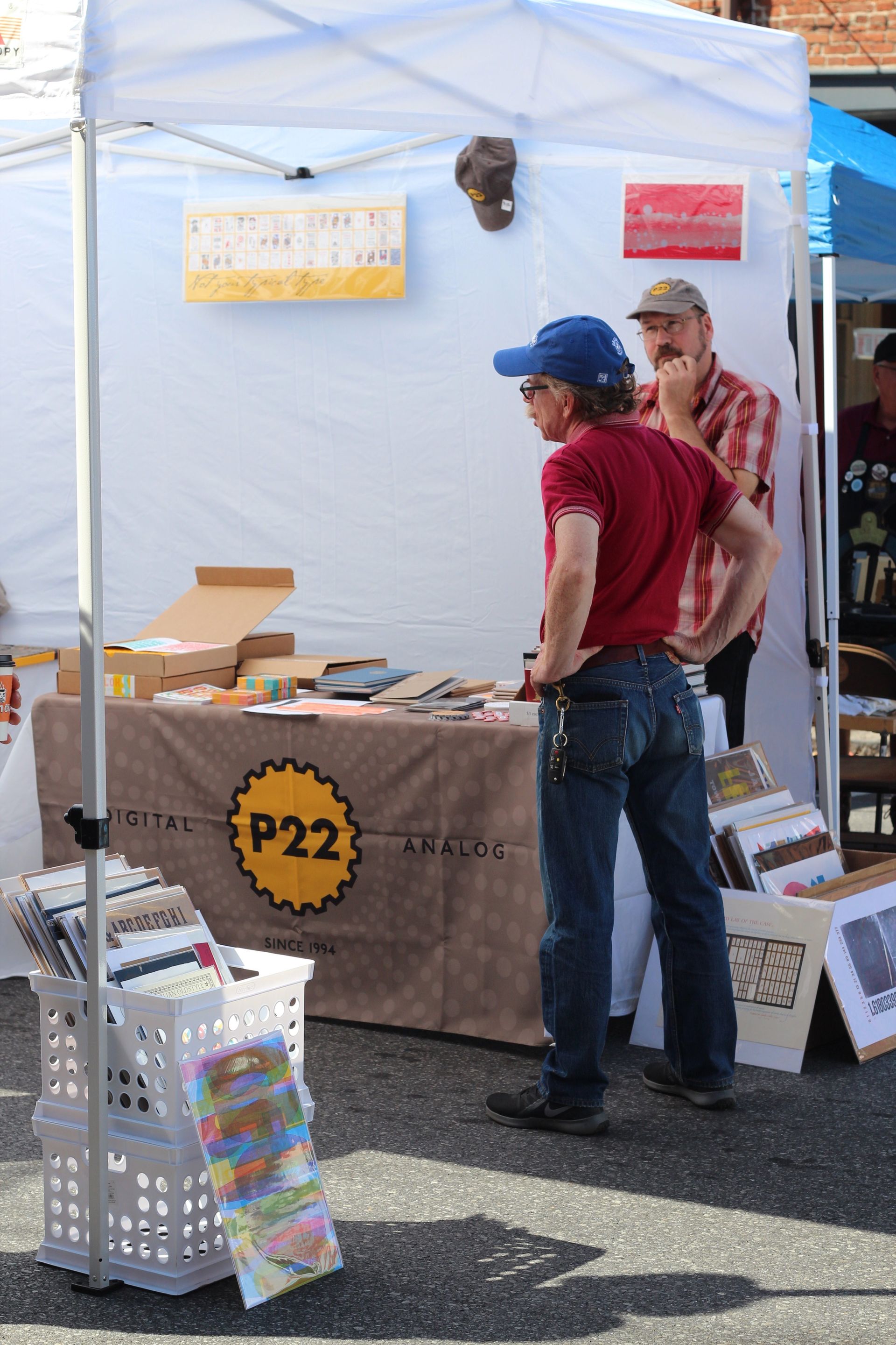 A man standing in front of a table that says p22 on it