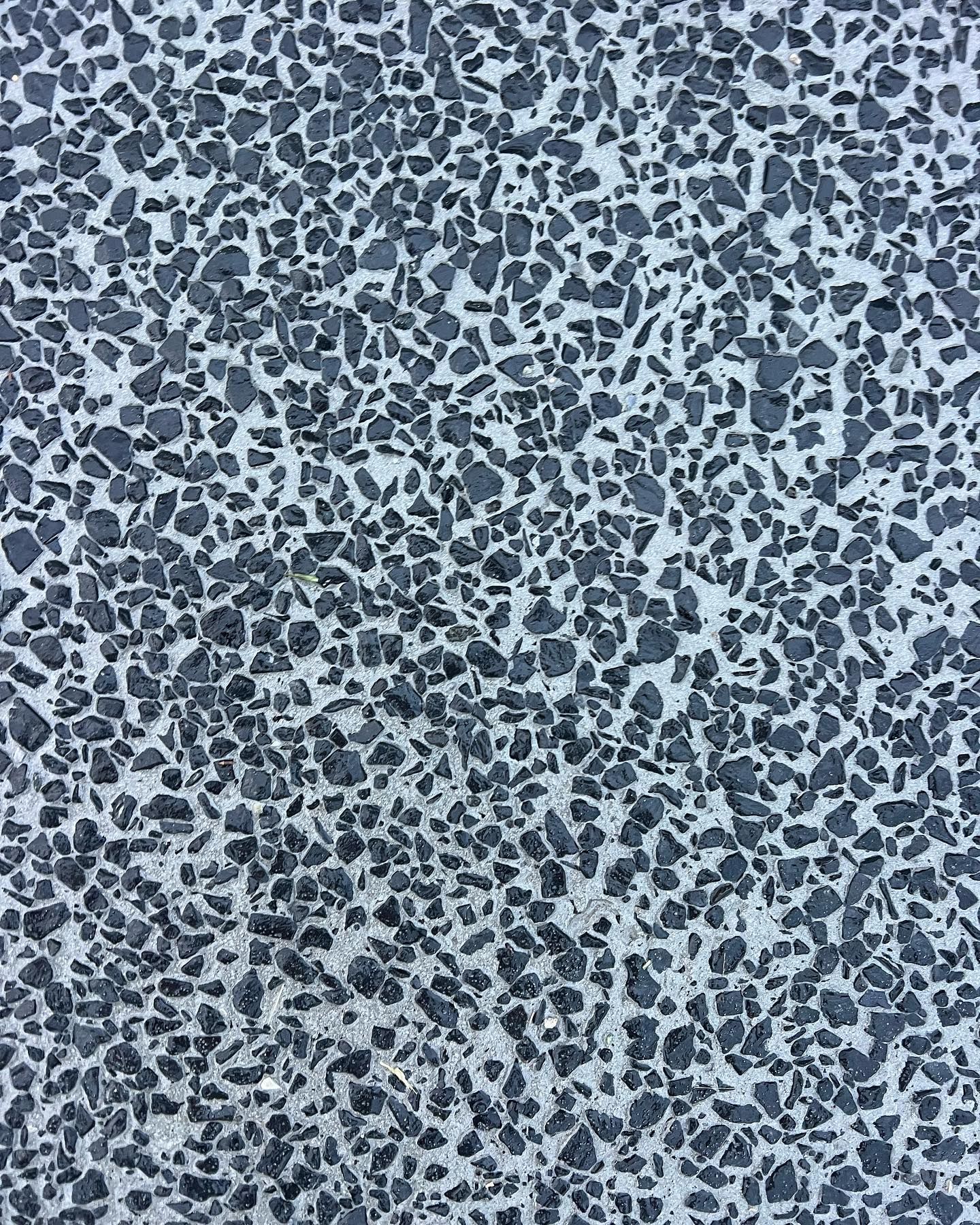 Close-up of a gray and black speckled terrazzo or pebble-textured surface