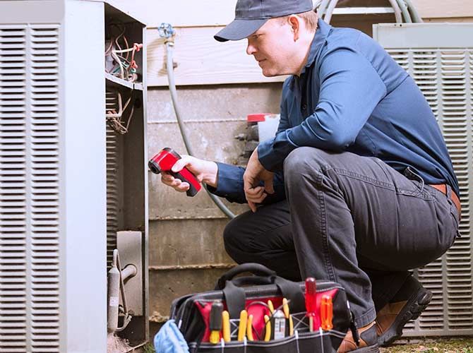 Man Checking Up Air Condition - New Castle, PA - Central Heating & Plumbing Man Checking Up Air Condition - New Castle, PA - Central Heating & Plumbing