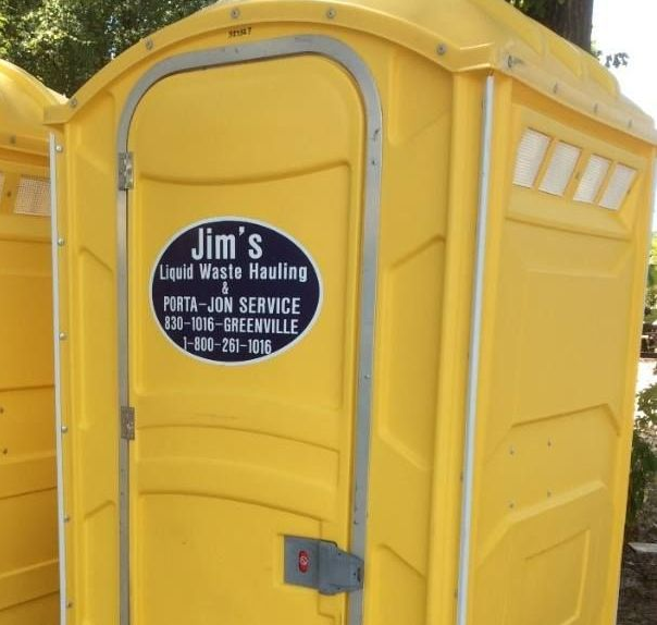 Yellow portable toilet with Jim’s Liquid Waste Hauling service sign on the door