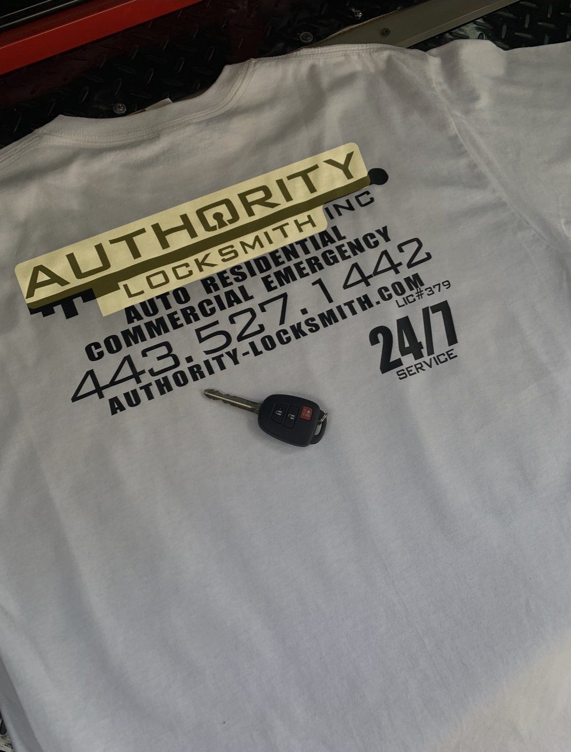 Authority Locksmith Inc shirt with LIC#379 and a car key