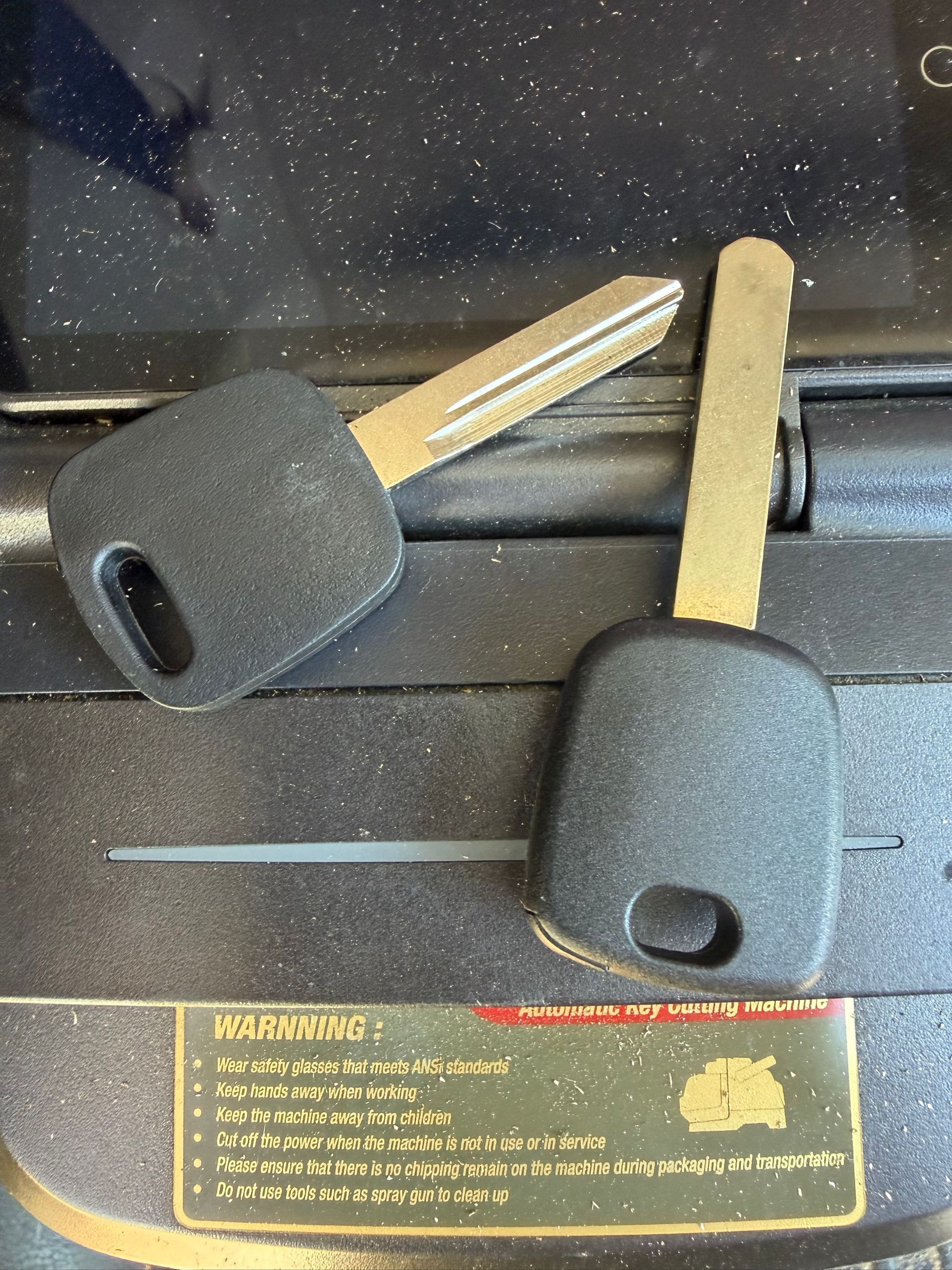 Two transponder car keys on a key cutting machine