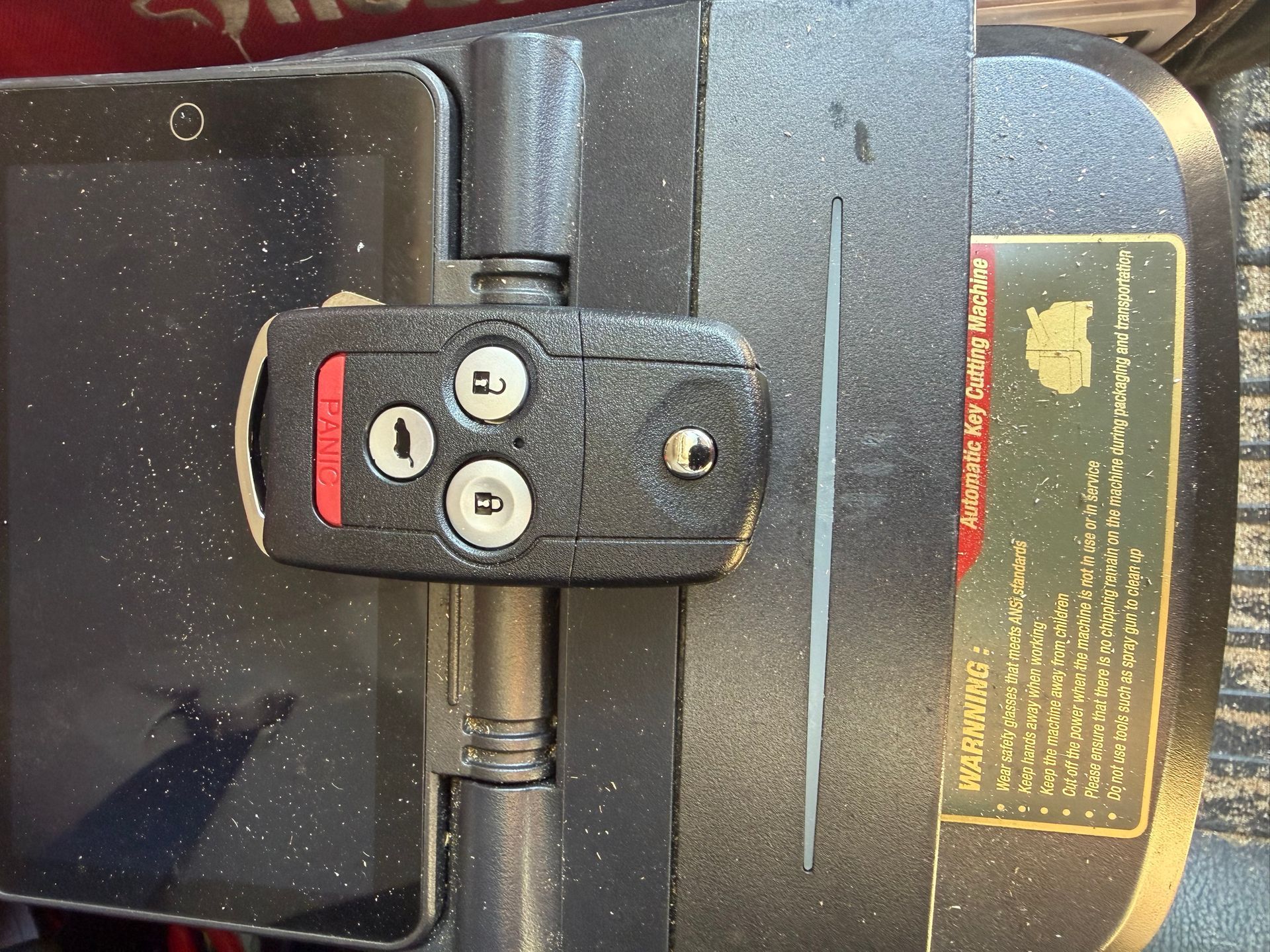 Remote flip key clamped in a key cutting machine
