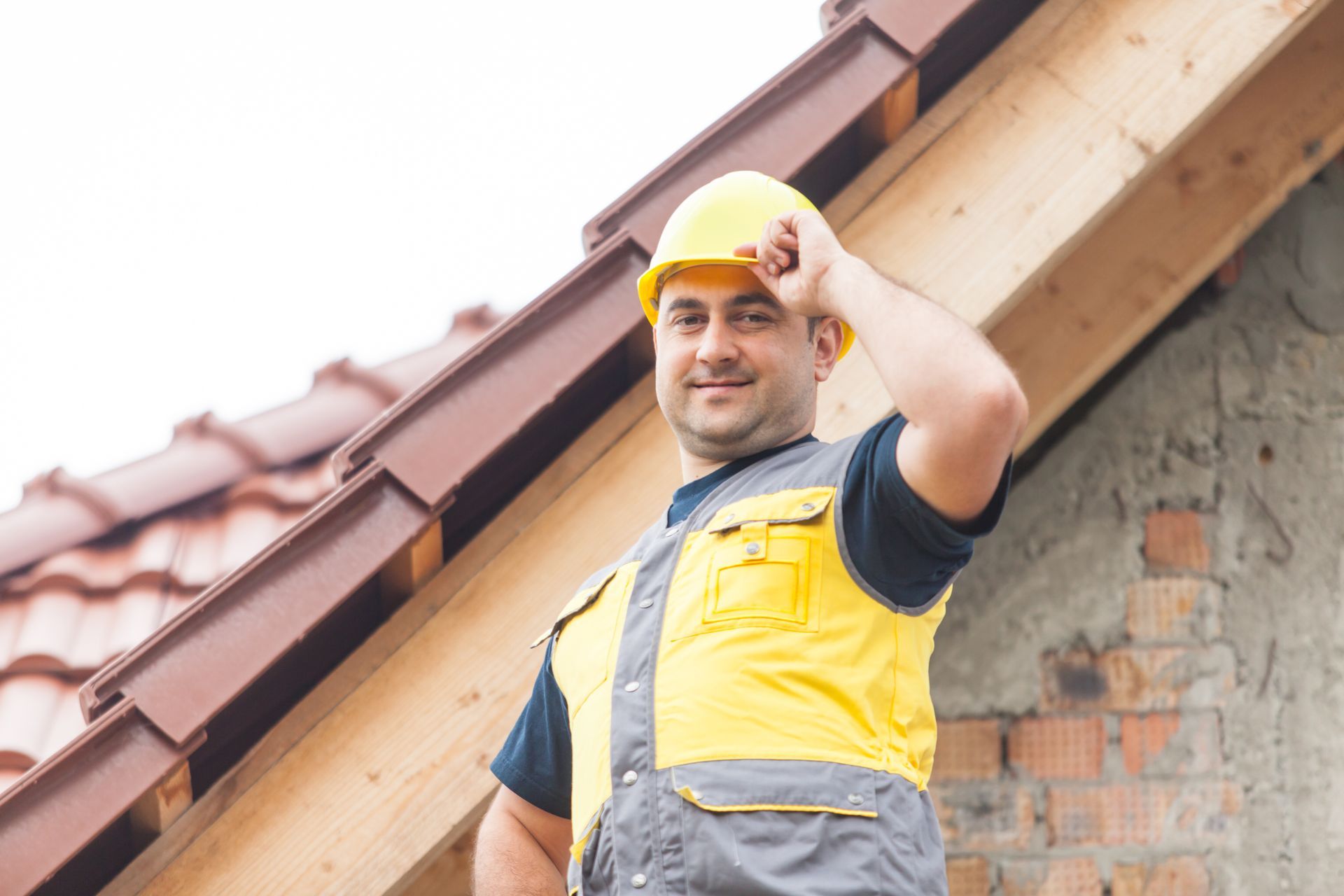 Home inspector examines architectural asphalt shingled roof